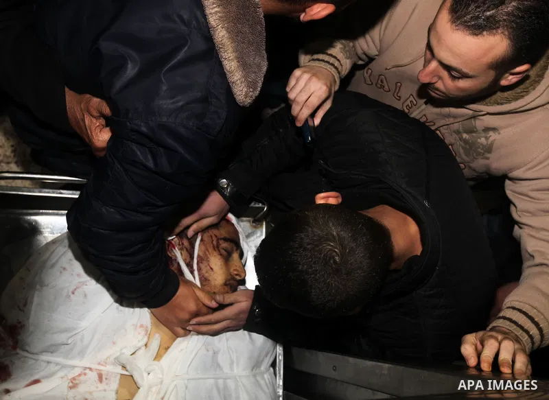 Relatives of Ahmed salem, 22-year-old, look at his body in the morgue of Al-Shifa hospital in Gaza City, on March 11, 2012, following a fresh Israeli air raid, bringing the death toll from strikes since March 10 to 17 an...
