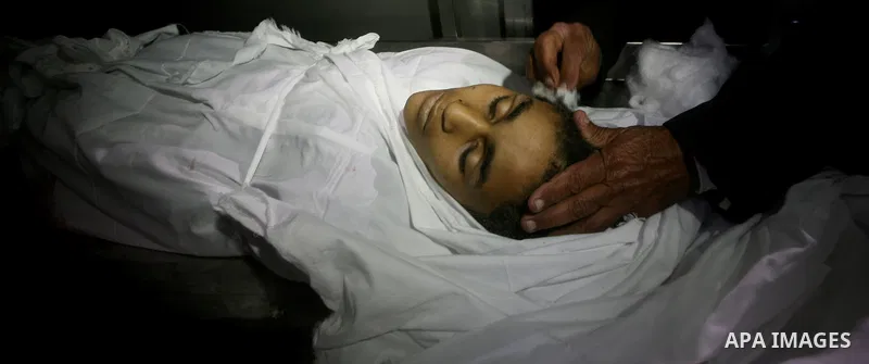 Relatives of Ayoub Assalya, 12-year-old, look at his body in the morgue of Kamal Edwan hospital in Beit Lahia in the northern Gaza Strip, on March 11, 2012, following a fresh Israeli air raid, bringing the death toll fro...