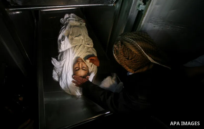 Relatives of Ayoub Assalya, 12-year-old, look at his body in the morgue of Kamal Edwan hospital in Beit Lahia in the northern Gaza Strip, on March 11, 2012, following a fresh Israeli air raid, bringing the death toll fro...
