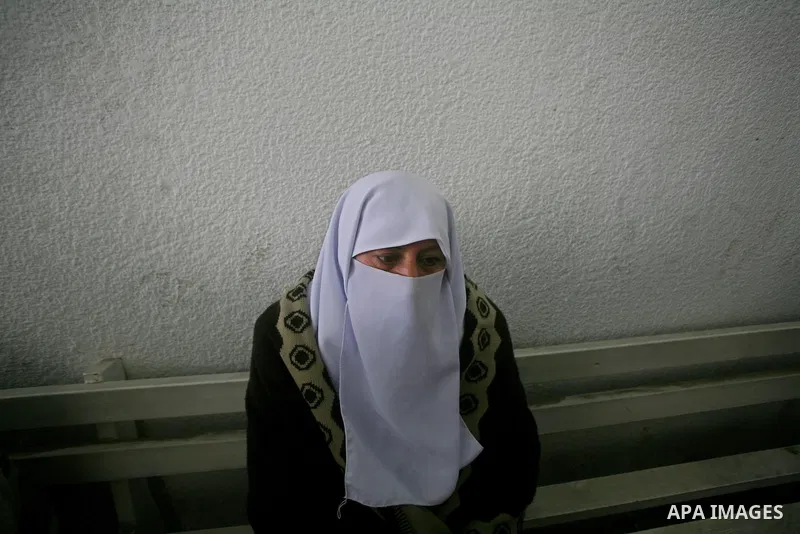 A relatives of Ayoub Asalya, 12-year-old, grieves over his body in the morgue of Kamal Edwan hospital in Beit Lahia in the northern Gaza Strip, on March 11, 2012, following a fresh Israeli air raid, bringing the death to...