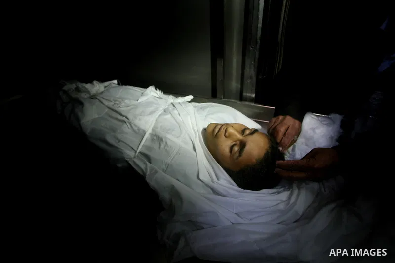 Relatives of Ayoub Assalya, 12-year-old, look at his body in the morgue of Kamal Edwan hospital in Beit Lahia in the northern Gaza Strip, on March 11, 2012, following a fresh Israeli air raid, bringing the death toll fro...