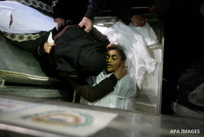 Relatives of Ayoub Assalya, 12-year-old, look at his body in the morgue of Kamal Edwan hospital in Beit Lahia in the northern Gaza Strip, on March 11, 2012, following a fresh Israeli air raid, bringing the death toll fro...