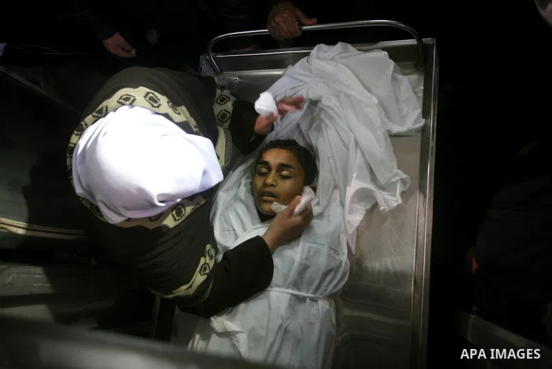 Relatives of Ayoub Assalya, 12-year-old, look at his body in the morgue of Kamal Edwan hospital in Beit Lahia in the northern Gaza Strip, on March 11, 2012, following a fresh Israeli air raid, bringing the death toll fro...