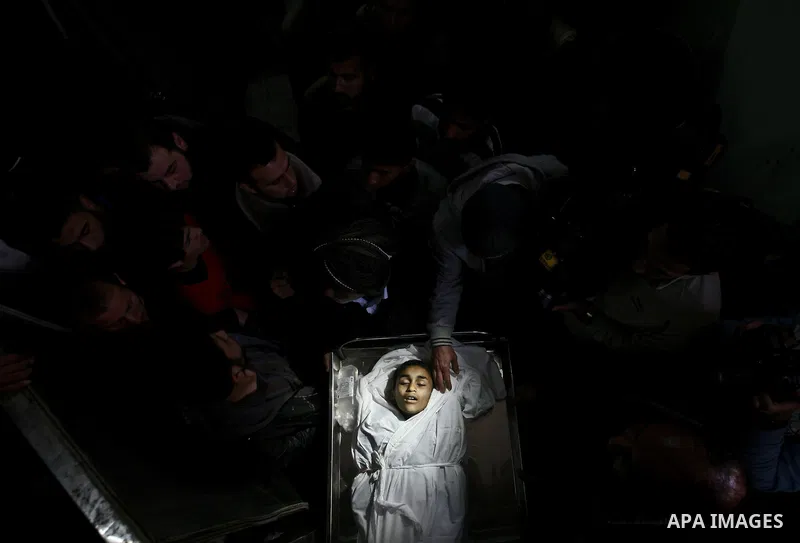 The body of Palestinian boy Ayoub Asalya, 12-year-old, lies in the morgue of Kamal Edwan hospital in Beit Lahia in the northern Gaza Strip, on March 11, 2012, following a fresh Israeli air raid, bringing the death toll f...