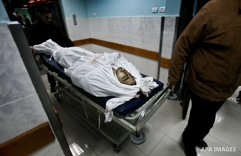 Relatives of Ahmed salem, 22-year-old, look at his body in the morgue of Al-Shifa hospital in Gaza City, on March 11, 2012, following a fresh Israeli air raid, bringing the death toll from strikes since March 10 to 17 an...