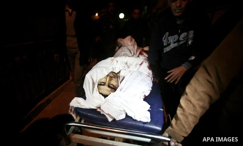 Relatives of Ahmed salem, 22-year-old, look at his body in the morgue of Al-Shifa hospital in Gaza City, on March 11, 2012, following a fresh Israeli air raid, bringing the death toll from strikes since March 10 to 17 an...