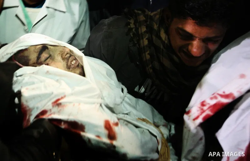 Relatives of Ahmed salem, 22-year-old, look at his body in the morgue of Al-Shifa hospital in Gaza City, on March 11, 2012, following a fresh Israeli air raid, bringing the death toll from strikes since March 10 to 17 an...