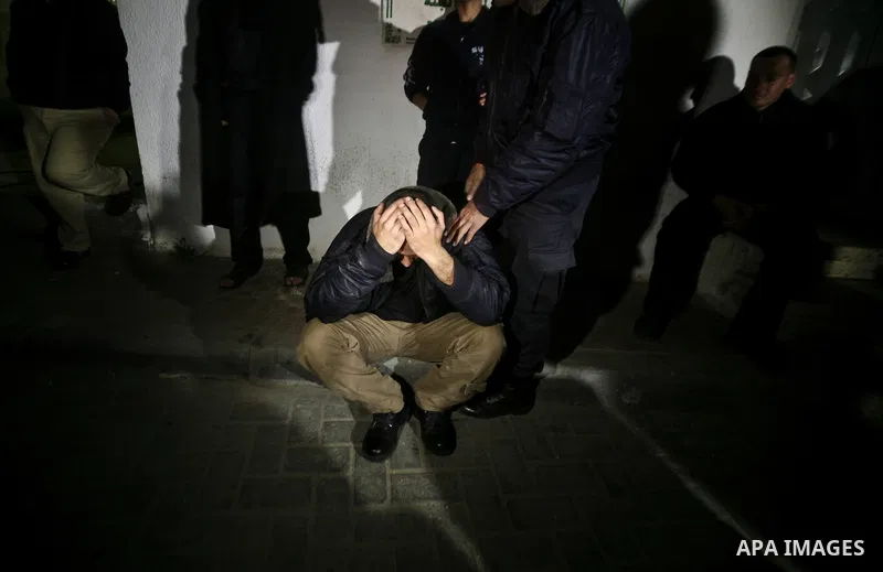 Relatives of Ahmed salem, 22-year-old, grieves over his body in the morgue of Al-Shifa hospital in Gaza City, on March 11, 2012, following a fresh Israeli air raid, bringing the death toll from strikes since March 10 to...
