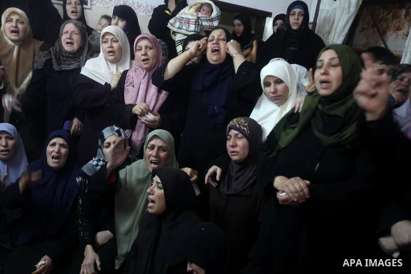 Palestinian female relatives of Ahmed Salim, one of the Nasser Salahaldin Brigades militants who was killed in an Israeli air strike, grieve during his funeral in Gaza City, on March 11, 2012. Photo by Ashraf Amra