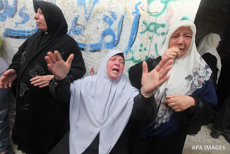 The mother of Ahmed Salim, one of the Nasser Salahaldin Brigades militants who was killed in an Israeli air strike, grieves during his funeral in Gaza City, on March 11, 2012. Photo by Ashraf Amra