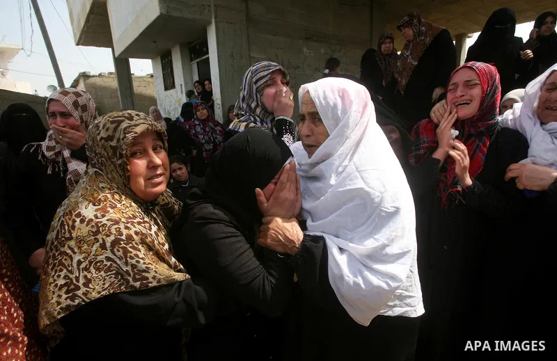 Palestinians women react during the funeral of 12 year old Ayoub Assalya killed in an Israeli airstrike in Jabaliya Refugee Camp, Gaza Strip Sunday, March 11, 2012. The worst round of violence in more than a year between...