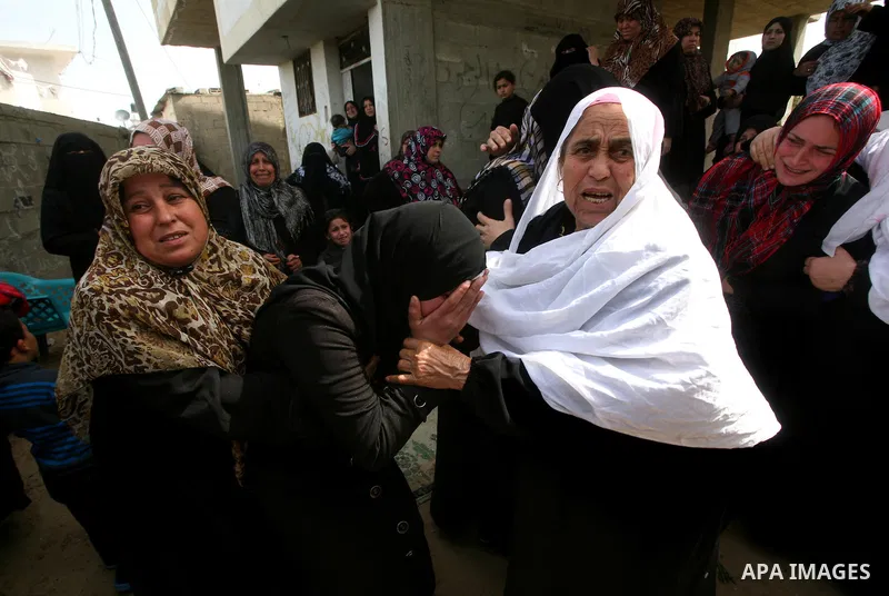 Palestinians women react during the funeral of 12 year old Ayoub Assalya killed in an Israeli airstrike in Jabaliya Refugee Camp, Gaza Strip Sunday, March 11, 2012. The worst round of violence in more than a year between...