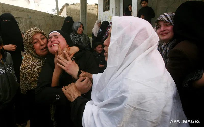 Palestinians women react during the funeral of 12 year old Ayoub Assalya killed in an Israeli airstrike in Jabaliya Refugee Camp, Gaza Strip Sunday, March 11, 2012. The worst round of violence in more than a year between...