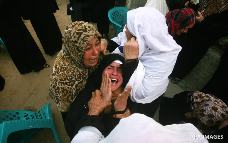 Palestinians women react during the funeral of 12 year old Ayoub Assalya killed in an Israeli airstrike in Jabaliya Refugee Camp, Gaza Strip Sunday, March 11, 2012. The worst round of violence in more than a year between...