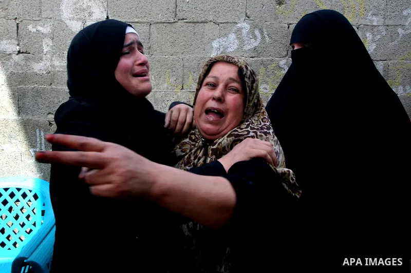 Palestinians women react during the funeral of 12 year old Ayoub Assalya killed in an Israeli airstrike in Jabaliya Refugee Camp, Gaza Strip Sunday, March 11, 2012. The worst round of violence in more than a year between...