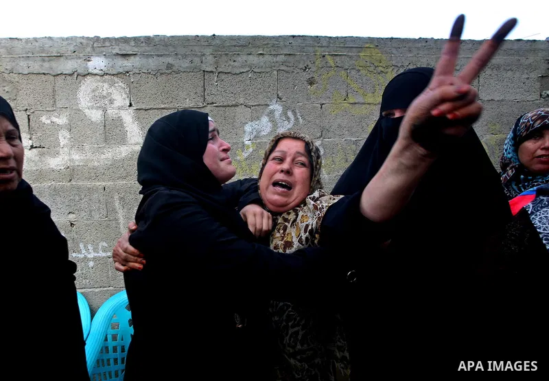 Palestinians women react during the funeral of 12 year old Ayoub Assalya killed in an Israeli airstrike in Jabaliya Refugee Camp, Gaza Strip Sunday, March 11, 2012. The worst round of violence in more than a year between...