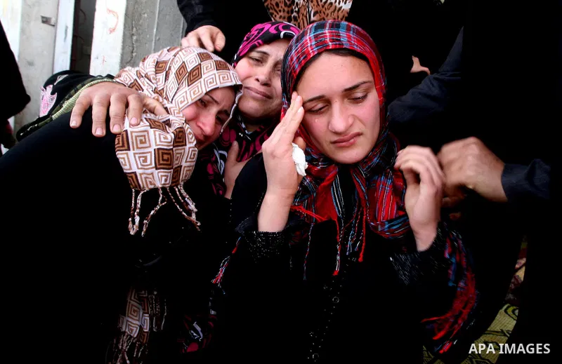 Palestinians women react during the funeral of 12 year old Ayoub Assalya killed in an Israeli airstrike in Jabaliya Refugee Camp, Gaza Strip Sunday, March 11, 2012. The worst round of violence in more than a year between...