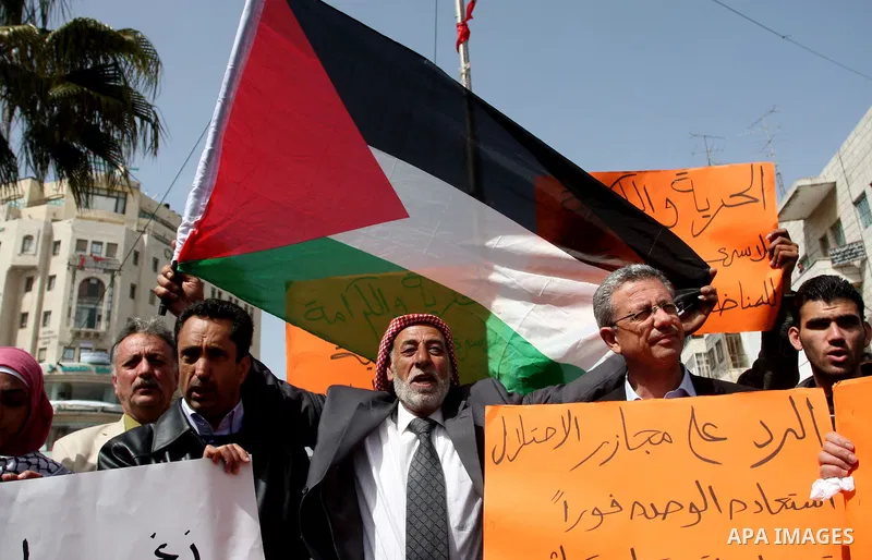 Dozens of Palestinians take part in a protest in the center of the West Bank city of Ramallah to show their support for the Gaza Strip and against Israeli air strikes, on March 11, 2012. Israel will continue air strikes...