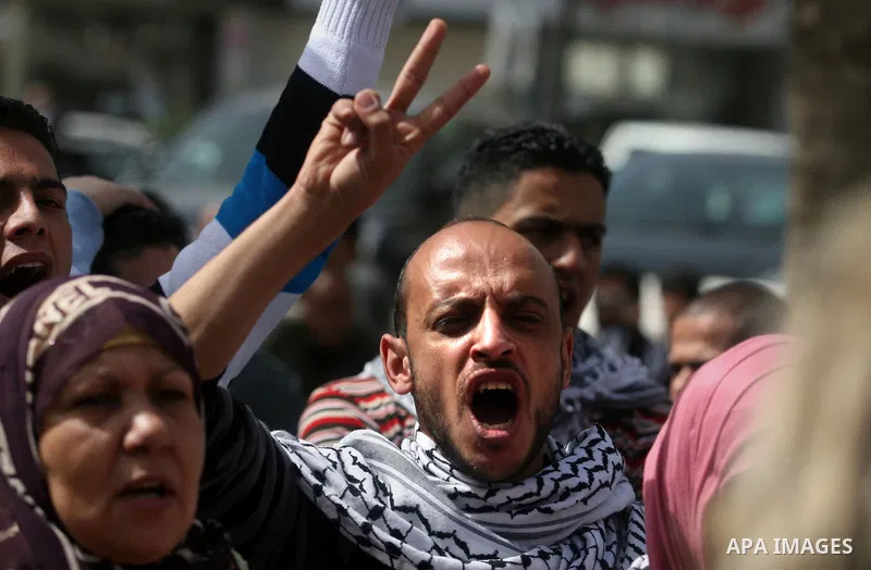 Dozens of Palestinians take part in a protest in the center of the West Bank city of Ramallah to show their support for the Gaza Strip and against Israeli air strikes, on March 11, 2012. Israel will continue air strikes...