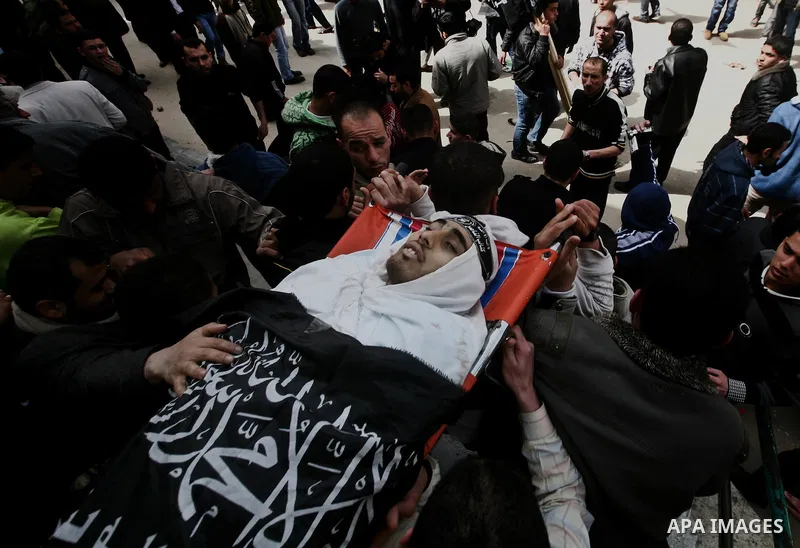 Palestinians carry the body of Ahmed Salim during his funeral in Gaza Strip Sunday, March 11, 2012. The worst round of violence in more than a year between Israel and Gaza Strip Palestinians deepened Sunday with deadly I...