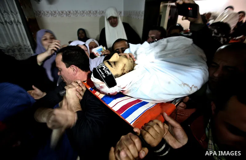 Palestinian relatives of Ahmed Salim, one of the Nasser Salah Addin Brigades who was killed in an Israeli air strike, mourn during his funeral in Gaza City,Sunday, March 11, 2012. Medics said Israeli air strikes on the G...