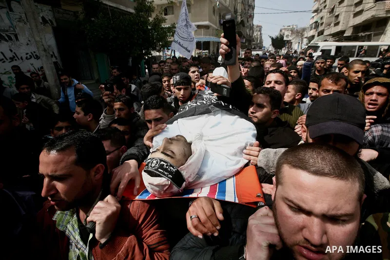 Palestinians carry the body of Ahmed Salim during his funeral in Gaza Strip Sunday, March 11, 2012. The worst round of violence in more than a year between Israel and Gaza Strip Palestinians deepened Sunday with deadly I...