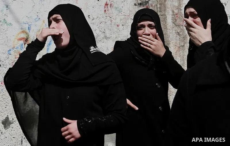 Palestinian relatives of Ahmed Salim, one of the Nasser Salah Addin Brigades who was killed in an Israeli air strike, mourn during his funeral in Gaza City,Sunday, March 11, 2012. Medics said Israeli air strikes on the G...