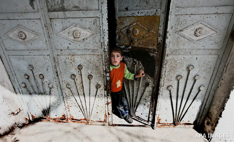 A Relative boy of Ahmed Salim, one of the Nasser Salah Addin Brigades who was killed in an Israeli air strike, mourn during his funeral in Gaza City,Sunday, March 11, 2012. Medics said Israeli air strikes on the Gaza Str...