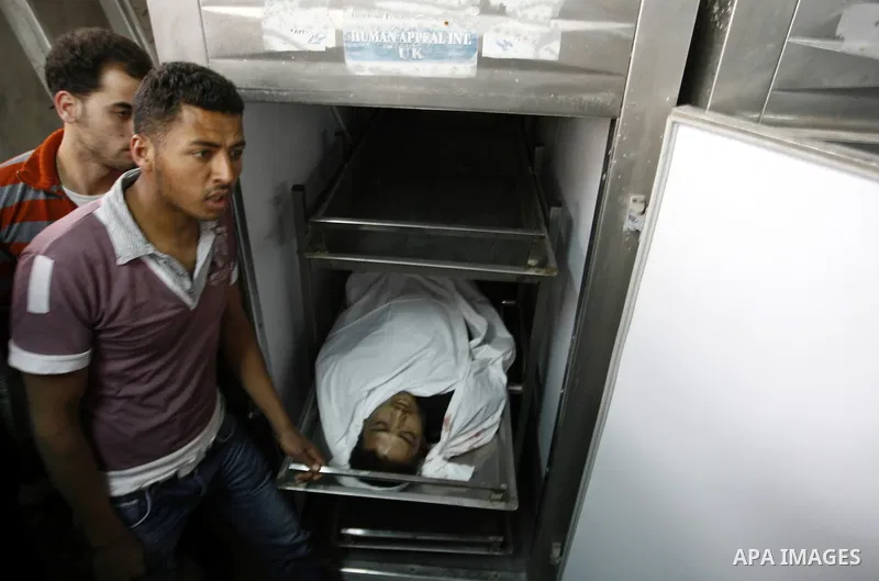 A Palestinian militant body is transported at a hospital Khan Younis in the southern Gaza Strip on March 12, 2012. Israeli air strikes killed two Palestinian militants and wounded 25 civilians in the Gaza Strip on Monday...