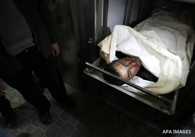 A Palestinian militant body is transported at a hospital Khan Younis in the southern Gaza Strip on March 12, 2012. Israeli air strikes killed two Palestinian militants and wounded 25 civilians in the Gaza Strip on Monday...