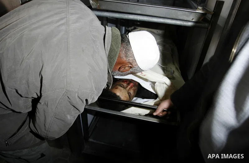 A Palestinian militant body is transported at a hospital Khan Younis in the southern Gaza Strip on March 12, 2012. Israeli air strikes killed two Palestinian militants and wounded 25 civilians in the Gaza Strip on Monday...