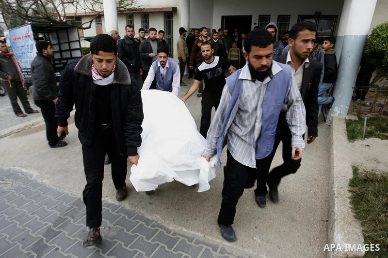 A Palestinian militant body is transported at a hospital Khan Younis in the southern Gaza Strip on March 12, 2012. Israeli air strikes killed two Palestinian militants and wounded 25 civilians in the Gaza Strip on Monday...