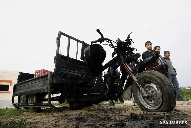 A Palestinian man reacts next to a rickshaw following an Israeli air strike in Khan Younis in the southern Gaza Strip on March 12, 2012. Israeli air strikes killed two Palestinian militants and wounded 25 civilians in th...