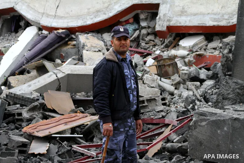 A Palestinian policeman inspects destruction after an Israeli air strike on a building in the northern Gaza Strip refugee camp of Jabalia on March 12, 2012. Israel launched a spate of air strikes killing at least two Pal...