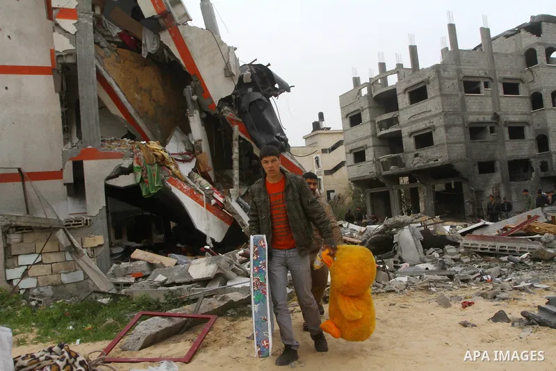 Palestinians inspect the destruction after an Israeli air strike on a building in the northern Gaza Strip refugee camp of Jabalia on March 12, 2012. Israel launched a spate of air strikes killing at least two Palestinian...
