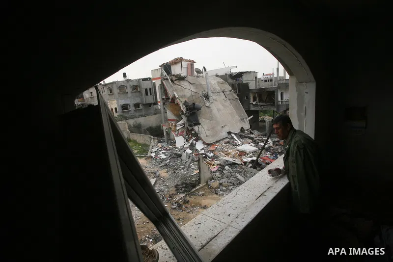 Palestinians inspect the destruction after an Israeli air strike on a building in the northern Gaza Strip refugee camp of Jabalia on March 12, 2012. Israel launched a spate of air strikes killing at least two Palestinian...
