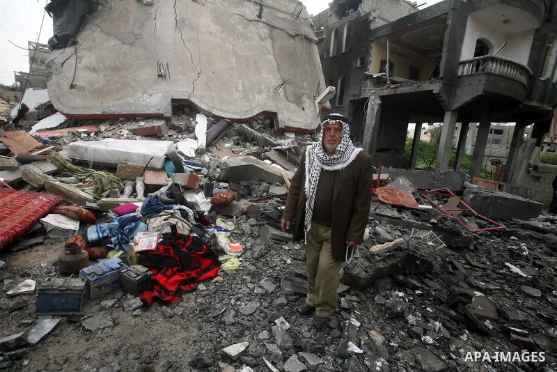 Palestinians inspect the destruction after an Israeli air strike on a building in the northern Gaza Strip refugee camp of Jabalia on March 12, 2012. Israel launched a spate of air strikes killing at least two Palestinian...