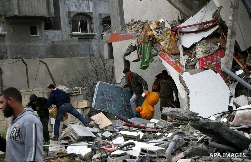 Palestinians inspect the destruction after an Israeli air strike on a building in the northern Gaza Strip refugee camp of Jabalia on March 12, 2012. Israel launched a spate of air strikes killing at least two Palestinian...