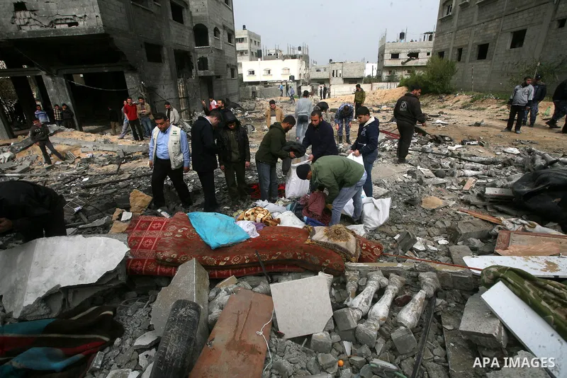 Palestinians inspect the destruction after an Israeli air strike on a building in the northern Gaza Strip refugee camp of Jabalia on March 12, 2012. Israel launched a spate of air strikes killing at least two Palestinian...