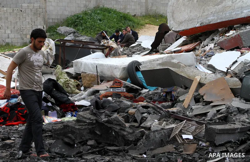 Palestinians inspect the destruction after an Israeli air strike on a building in the northern Gaza Strip refugee camp of Jabalia on March 12, 2012. Israel launched a spate of air strikes killing at least two Palestinian...