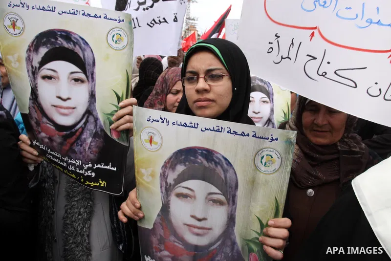 Palestinian women demonstrate in solidarity with Hana'a Shalabi during a protest in Gaza City, on Mar. 12, 2012. Shalabi, released by Israel in a prisoner swap last year but re-arrested earlier this month and held withou...
