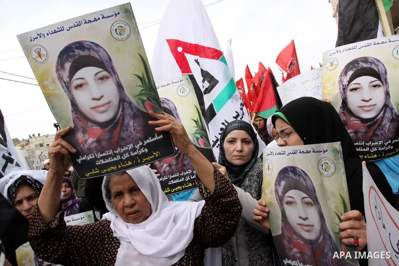 Palestinian women demonstrate in solidarity with Hana'a Shalabi during a protest in Gaza City, on Mar. 12, 2012. Shalabi, released by Israel in a prisoner swap last year but re-arrested earlier this month and held withou...