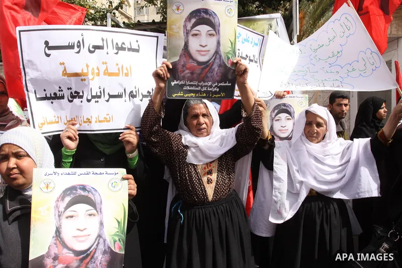 Palestinian women demonstrate in solidarity with Hana'a Shalabi during a protest in Gaza City, on Mar. 12, 2012. Shalabi, released by Israel in a prisoner swap last year but re-arrested earlier this month and held withou...
