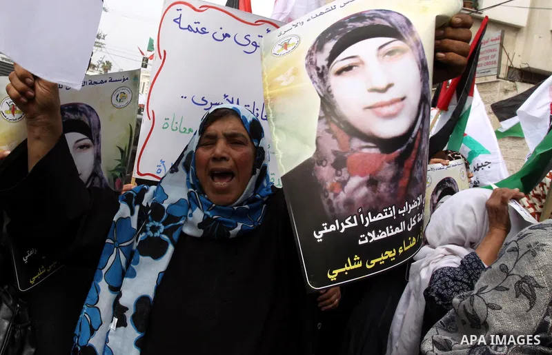 Palestinian women demonstrate in solidarity with Hana'a Shalabi during a protest in Gaza City, on Mar. 12, 2012. Shalabi, released by Israel in a prisoner swap last year but re-arrested earlier this month and held withou...
