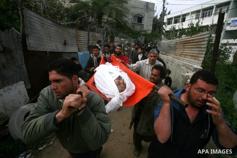Palestinian carry the body of Mohammed al-Hasoma, 65, killed in an Israeli air strike during his funeral in Beit Lahiya, northern Gaza Strip, Monday, March 12, 2012. The cross-border violence, touched off by Israel's kil...