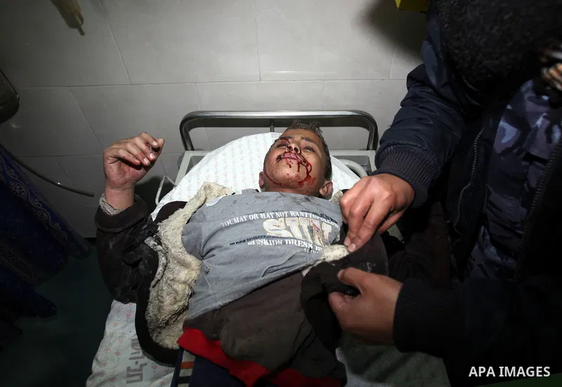 A wounded Palestinian boy is wheeled into a hospital in Gaza City, after an Israeli air strike March 12, 2012. Israeli air strikes killed two Palestinian militants and a civilian in the Gaza Strip on Monday in a fourth d...