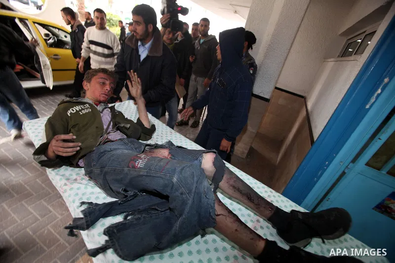 A wounded Palestinian boy is wheeled into a hospital in Gaza City, after an Israeli air strike March 12, 2012. Israeli air strikes killed two Palestinian militants and a civilian in the Gaza Strip on Monday in a fourth d...
