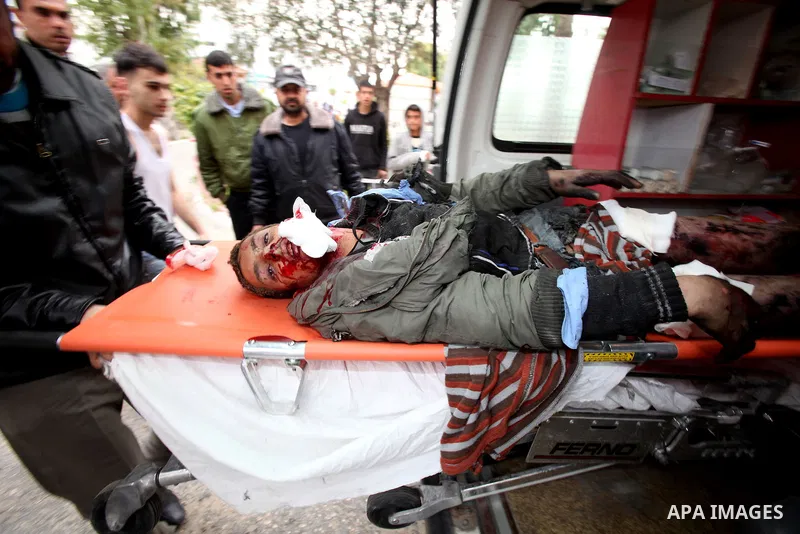 A wounded Palestinian boy is wheeled into a hospital in Gaza City, after an Israeli air strike March 12, 2012. Israeli air strikes killed two Palestinian militants and a civilian in the Gaza Strip on Monday in a fourth d...