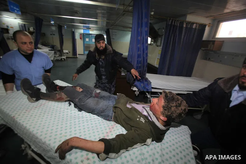 A wounded Palestinian boy is wheeled into a hospital in Gaza City, after an Israeli air strike March 12, 2012. Israeli air strikes killed two Palestinian militants and a civilian in the Gaza Strip on Monday in a fourth d...
