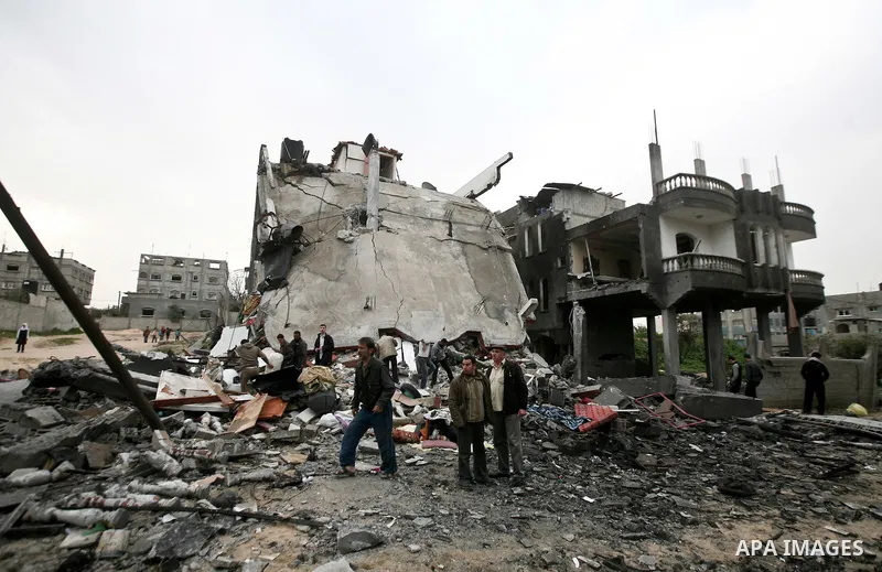 Palestinians amongst the rubble of a destroyed building of senior Islamic Jihad militant following an Israeli air strike in the east of Jabaliya refugee camp on, 12 March 2012. Reports state that an Israeli air strike on...